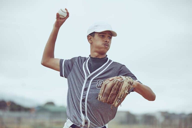 Young baseball player throwing a pitch